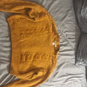 A gold knitted sweater size large